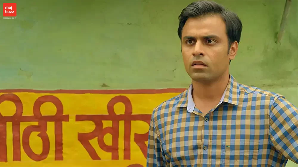 A man standing surprised and looking at someone shockingly in Panchayat Season 1