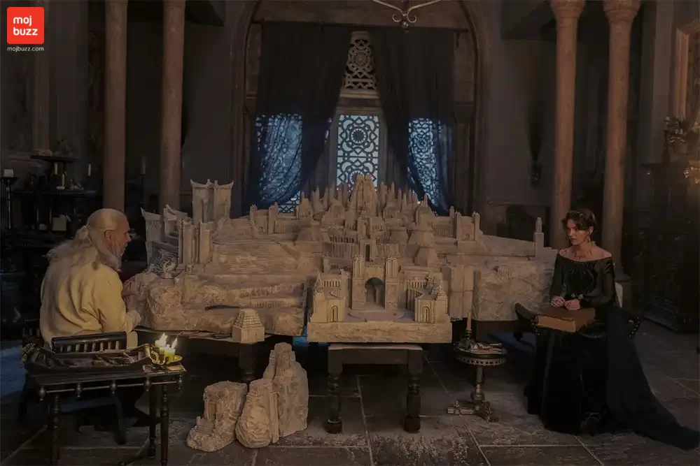 a man and a girl seating in front of a city model in house of the dragon series