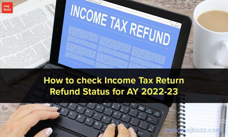 A person hand on laptop and income tax refund written on the screen