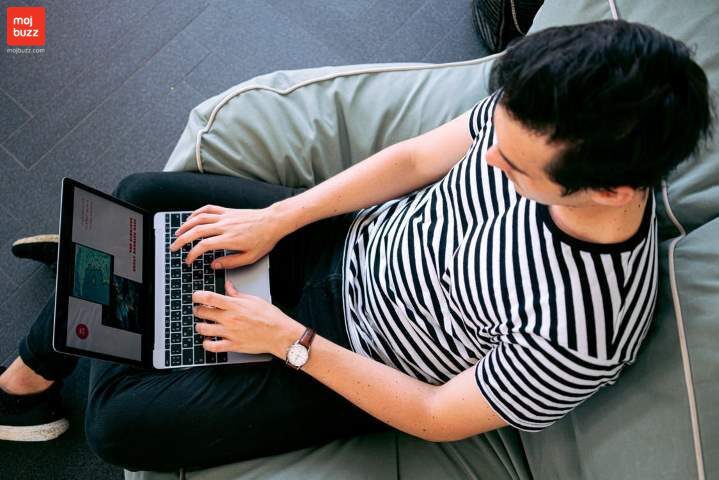 A man has a laptop in his lap seating on sofa image Top 10 Highest Paying Jobs