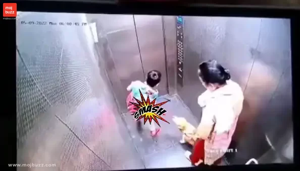 A woman and a boy inside a lift with a dog