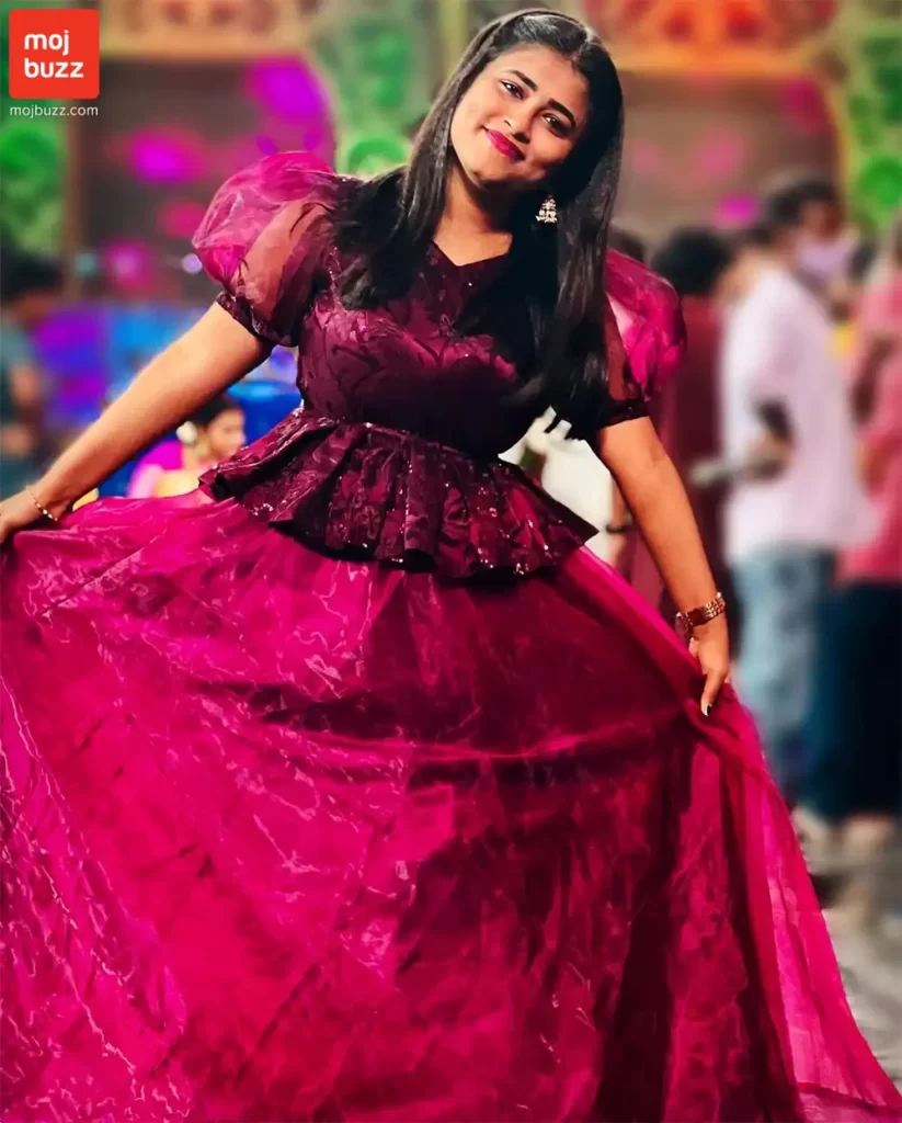 A girl (Geetu Royal) smiling in a pink dress