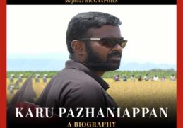 A man in goggles standing in a field farm. Karu Pazhaniappan biography