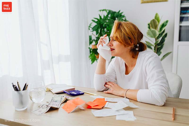A women crying and having a tissue paper in her hand