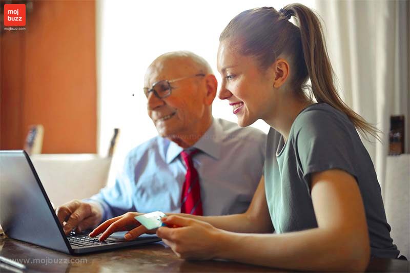 A old man seating with a younger girl in front of a laptop 10 Stupid things